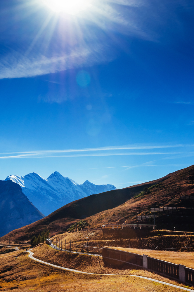 Panoramic view of deep valley on sunny day in autumn near Kleine Scheidegg Hiking trail, Jungfrau region, Switzerland