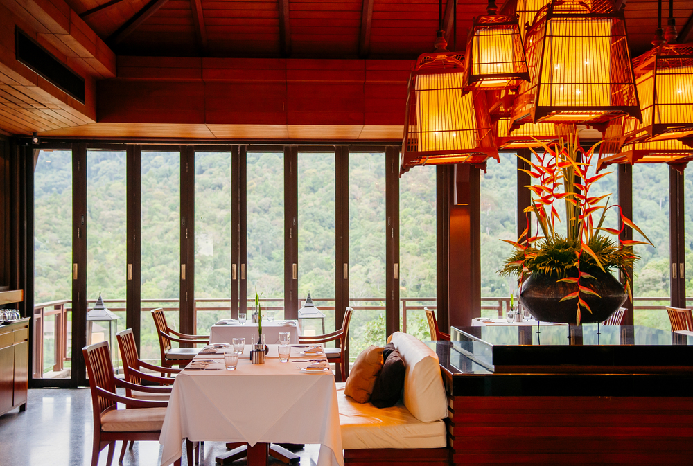MAY 17, 2014 Krabi, THAILAND - Asian luxury style hotel restaurant with contemporary wooden furnitures, chairs, tables , bird cage pedant lamps decoration