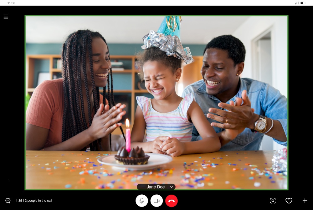 Portrait of a family celebrating birthday online on a video call with family and friends while staying at home. New normal lifestyle concept.