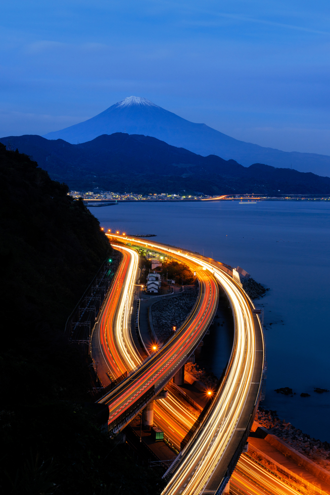 Aerial view of Mountain Fuji with express way, roads at night in Shizuoka. Fuji five lakes, Japan. Landscape with hills.