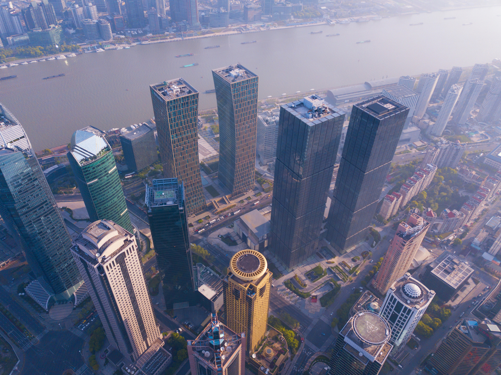 Aerial view of skyscraper and high-rise office buildings in Shanghai Downtown with Huangpu River, China. Financial district and business centers in smart city in Asia at sunrise.