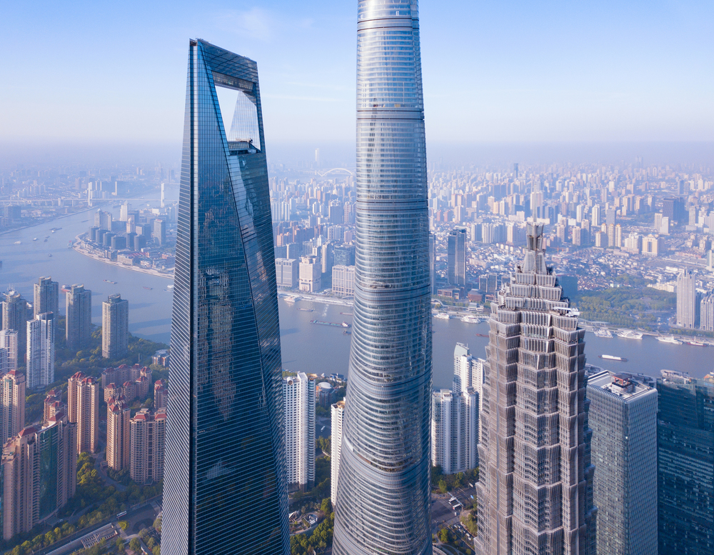 Aerial view of skyscraper and high-rise office buildings in Shanghai Downtown with Huangpu River, China. Financial district and business centers in smart city in Asia at sunrise.