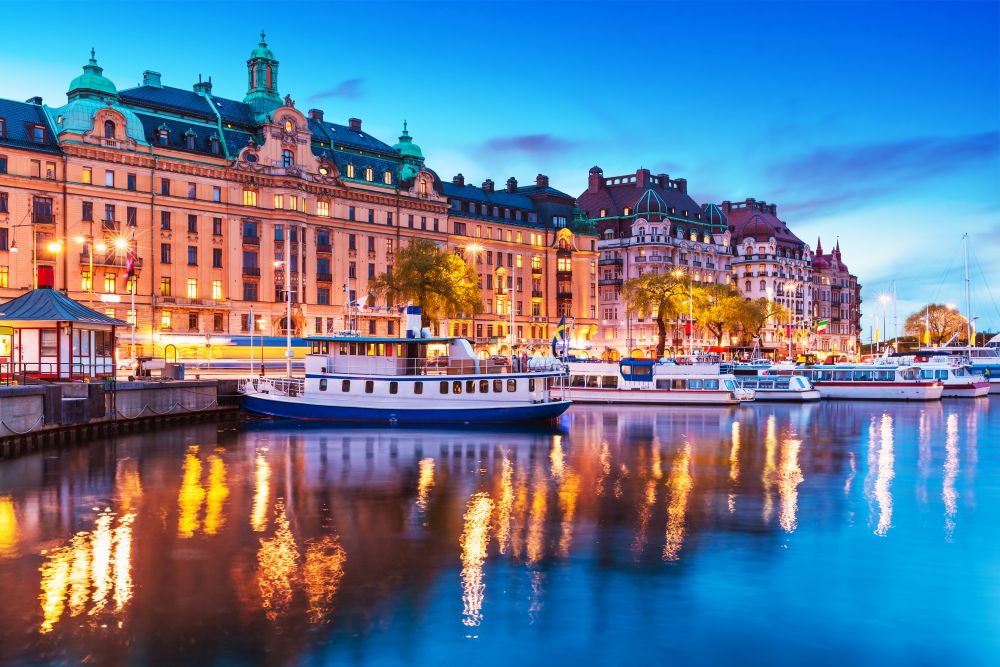 Scenic summer evening panorama of the Old Town (Gamla Stan) architecture pier with sightseeing travel ships and boats in Stockholm, Sweden