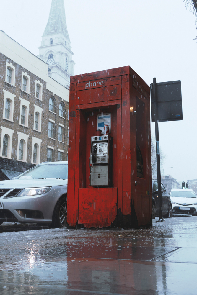 Old phone booth in London with snow