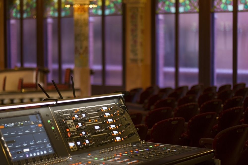 Sound technician control professional audio mixer in theater