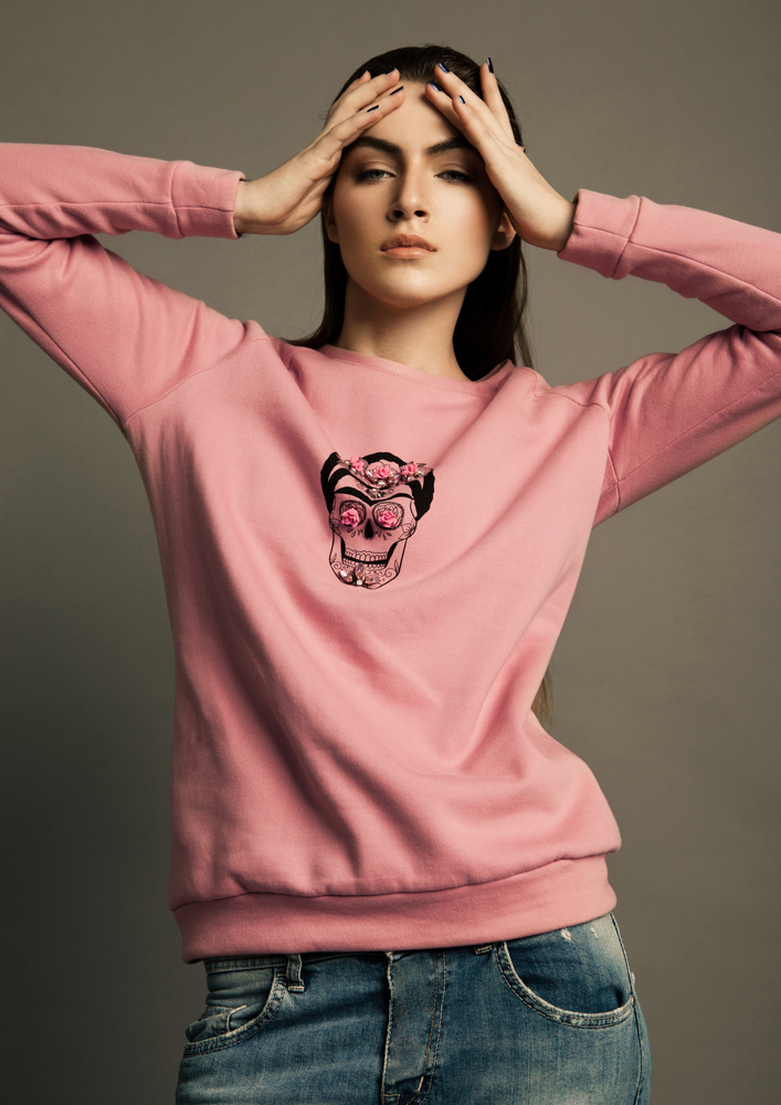 Beautiful fashion model wearing pink jumper skull in studio