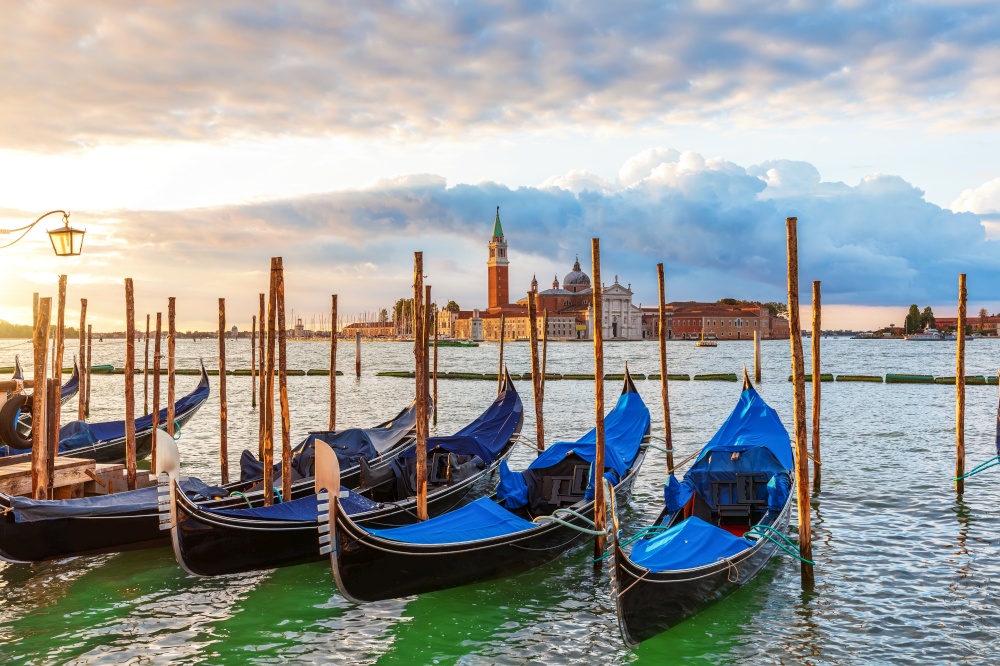 Gondolas moored in front of San Giorgio Maggiore Island in the lagoon of Venice, Italy.