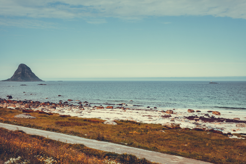 Seascape, sea coast with sandy beach and island Bleiksoya in the distance, resort Bleik Andoya Norway. Vesteralen archipelago.. Sea coast sandy beach in resort Bleik Andoya Norway