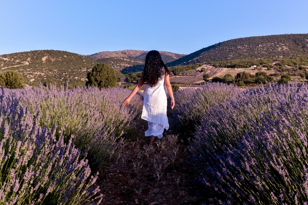 White woman with umbrella in lavender field in Turkey