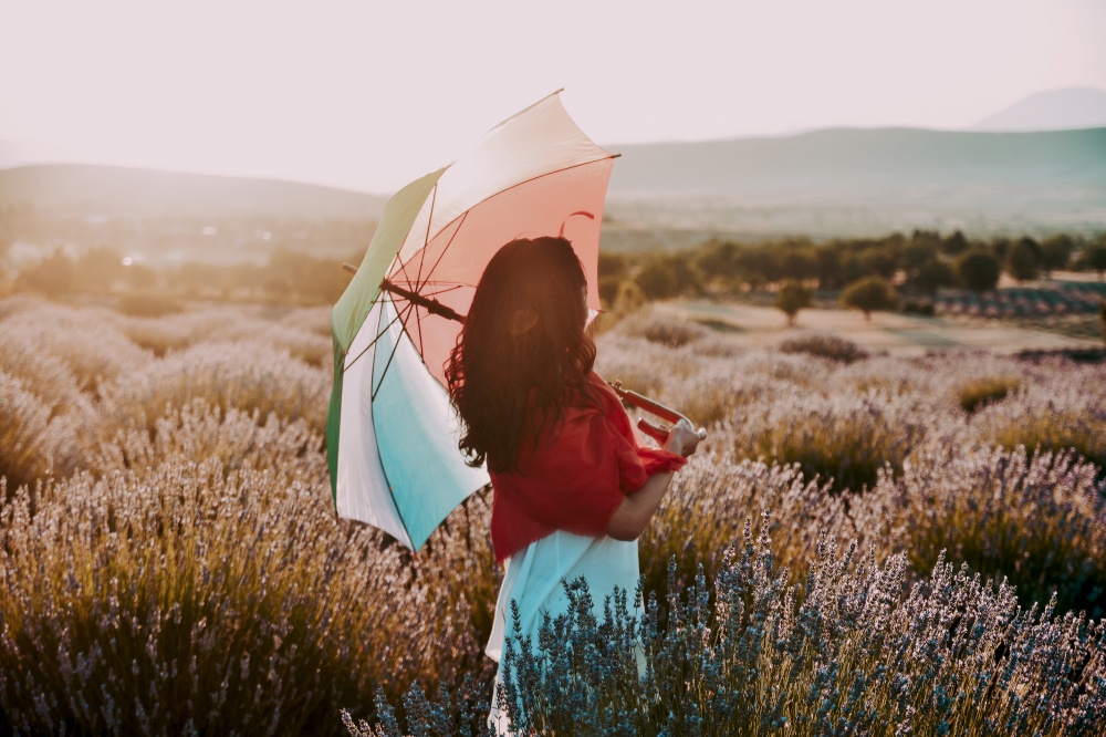 White woman with umbrella in lavender field in Turkey