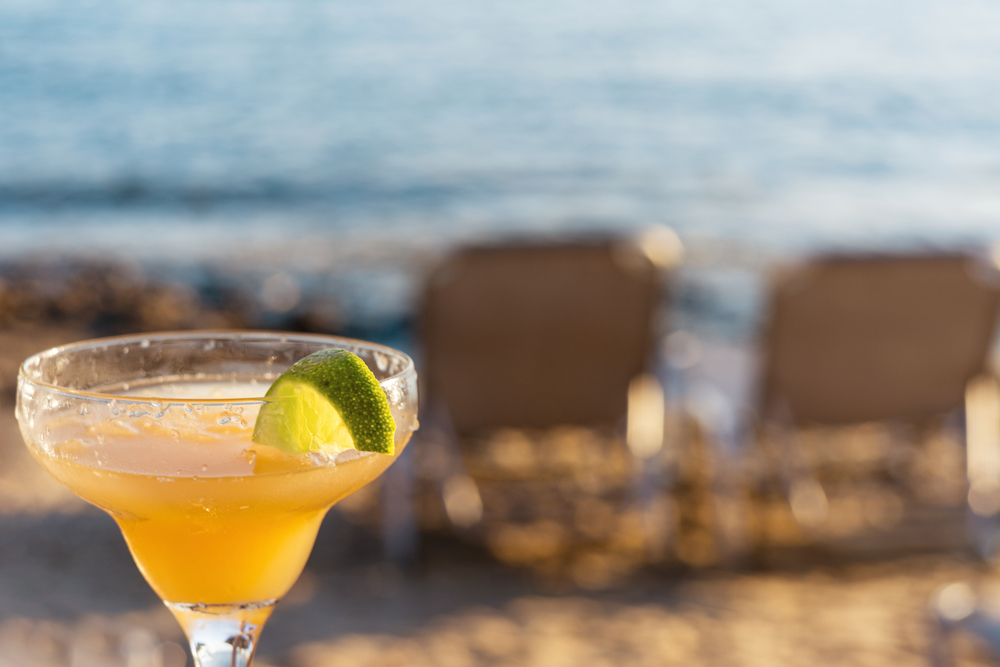 Refreshing Classic Margarita Cocktail With Lime And Salt By The Beach At Sunset On Blurred Background