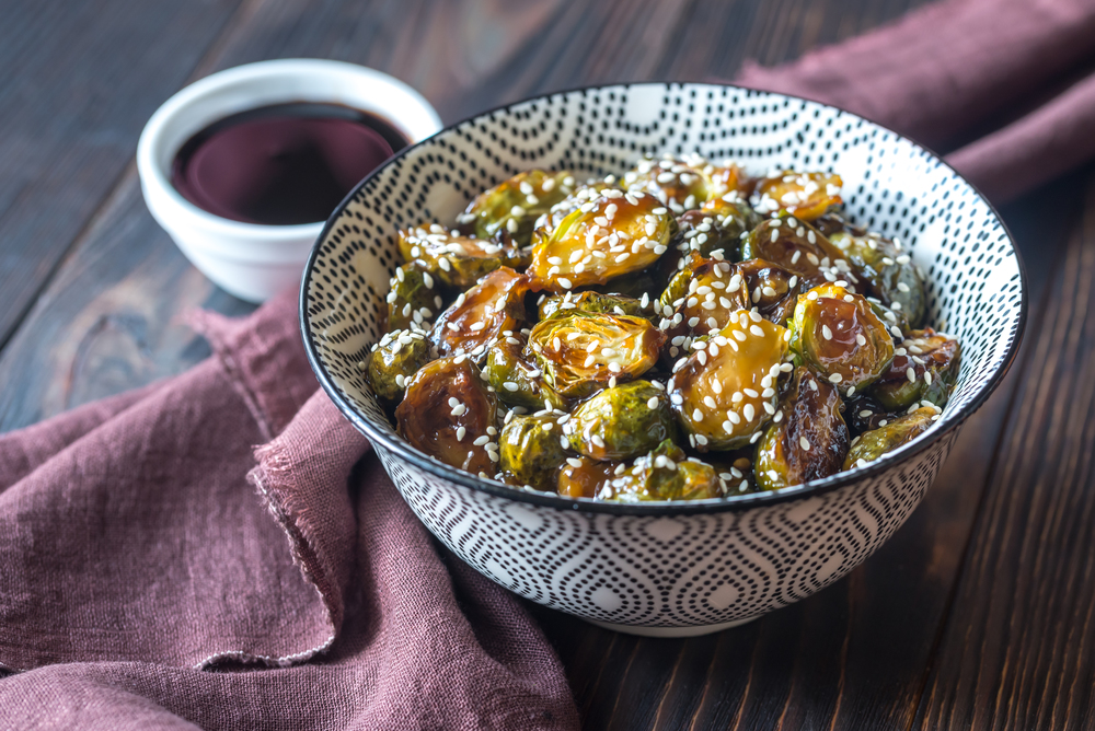 Bowl of roasted brussels sprouts with teriyaki sauce