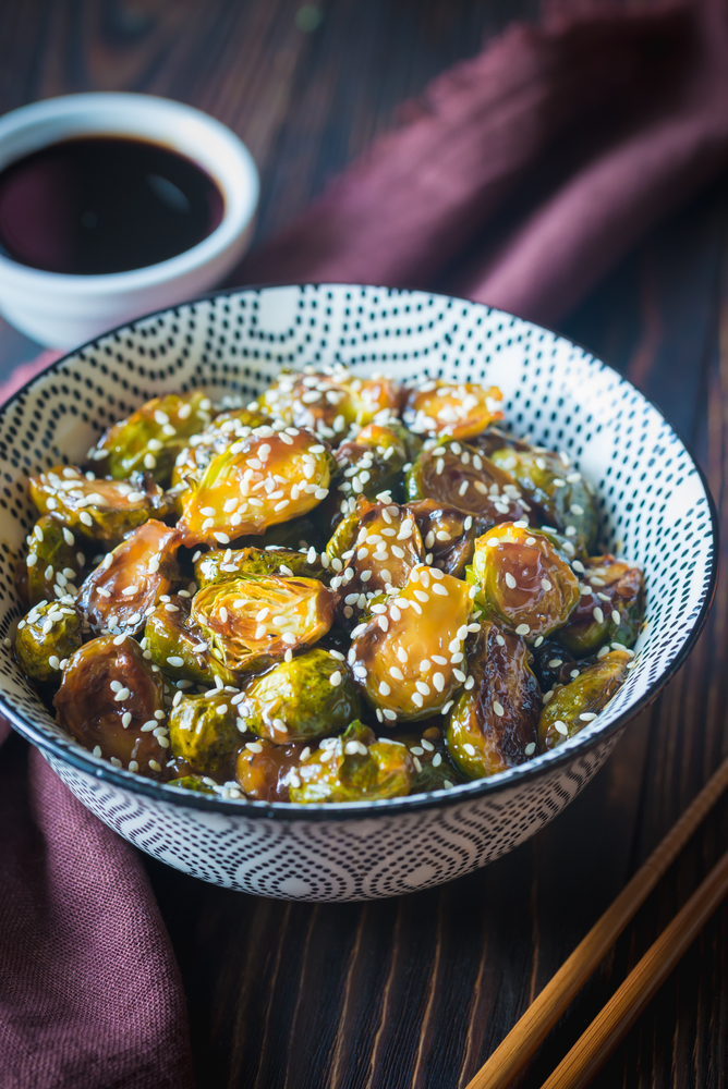 Bowl of roasted brussels sprouts with teriyaki sauce