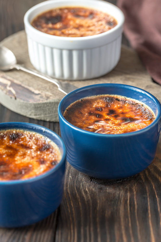 Creme brulee in the pots on the wooden board