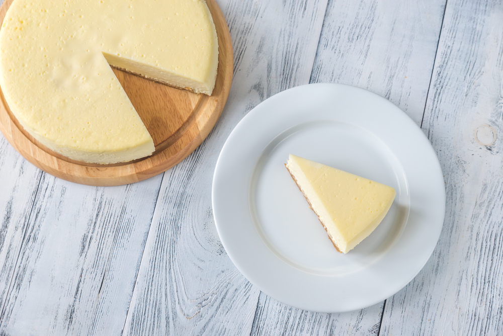 Traditional cheesecake on the wooden table flat lay