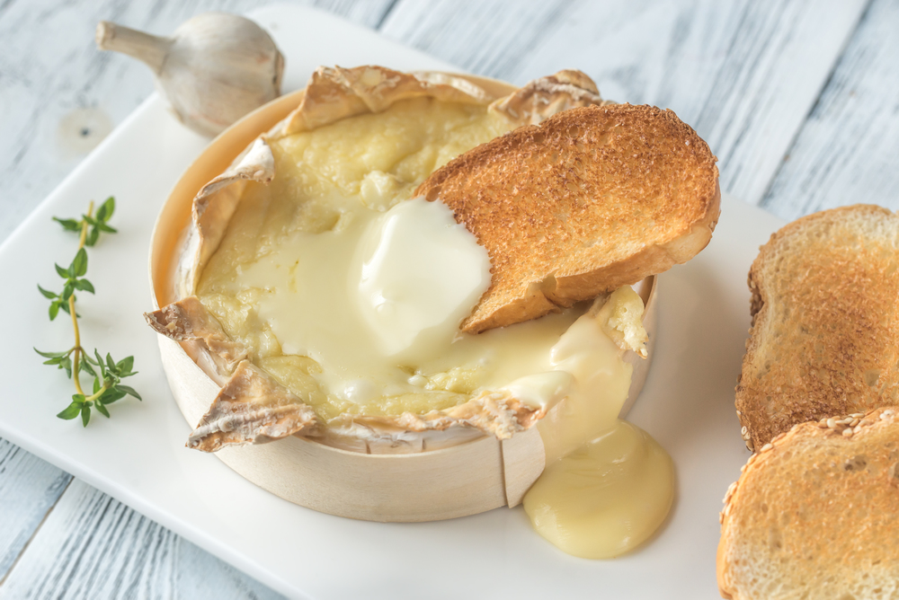 Baked Camembert cheese with toasted bread slices