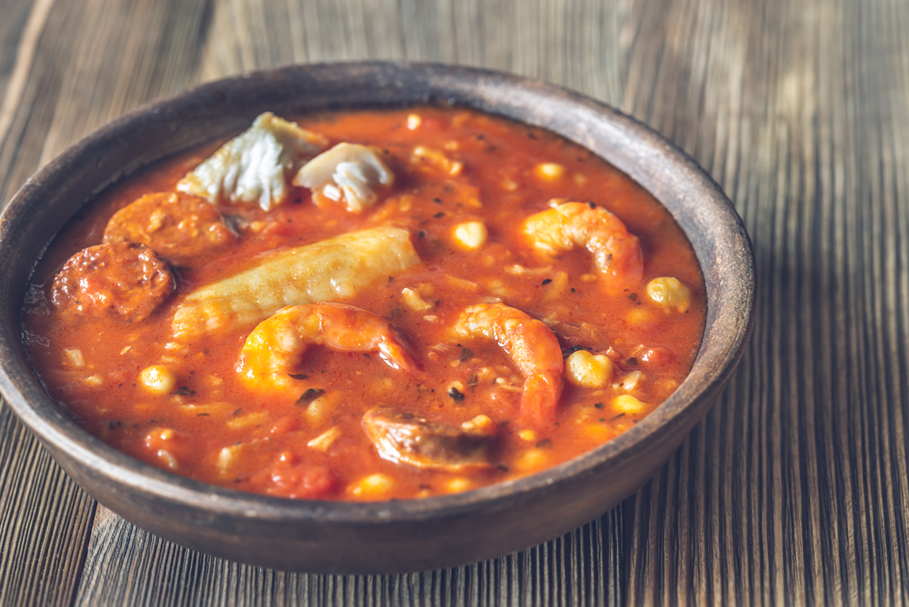 Portion of spanish fish and chorizo soup close-up