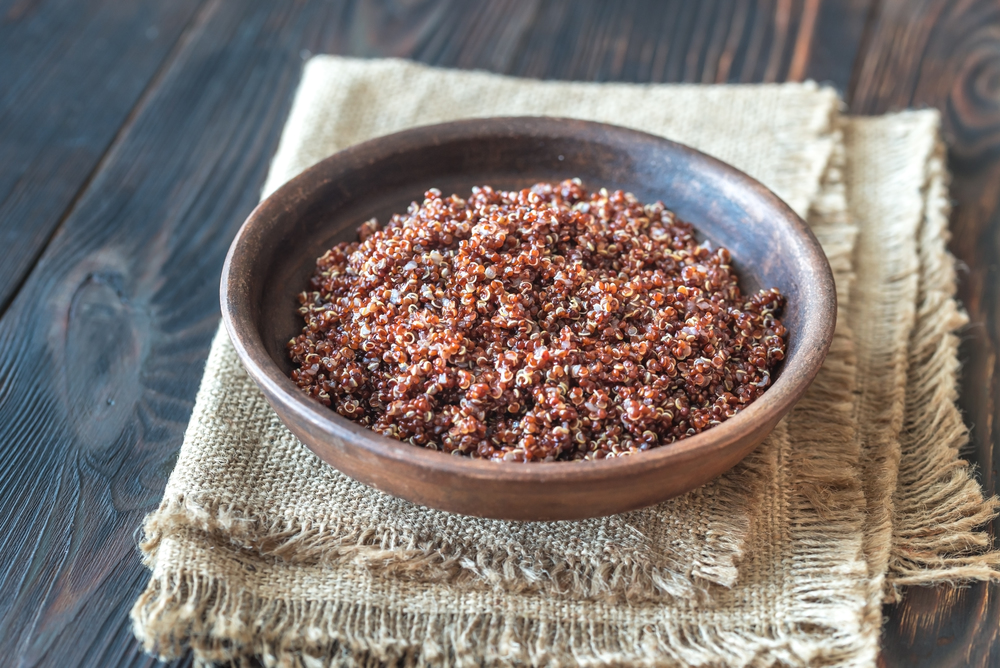Bowl of red quinoa on the wooden background