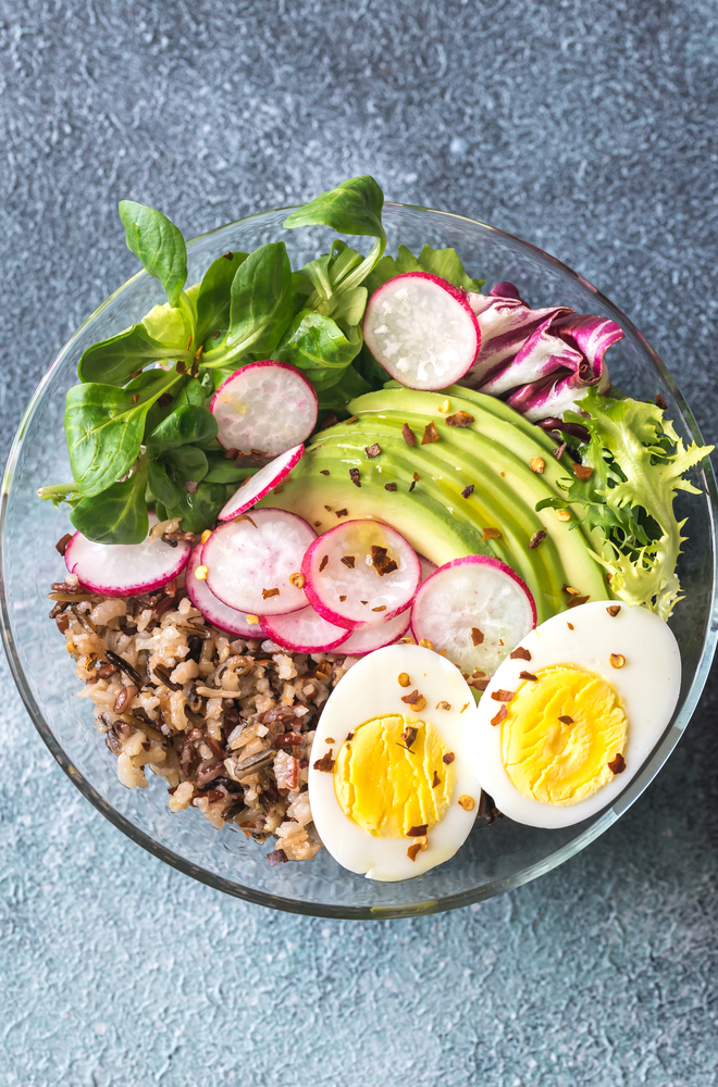 Bowl of wild rice with avocado, egg and lettuce