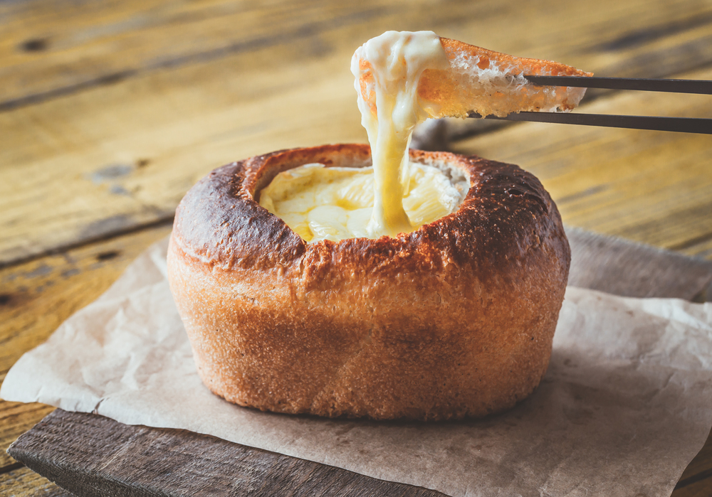 Camembert bread bowl on the wooden background