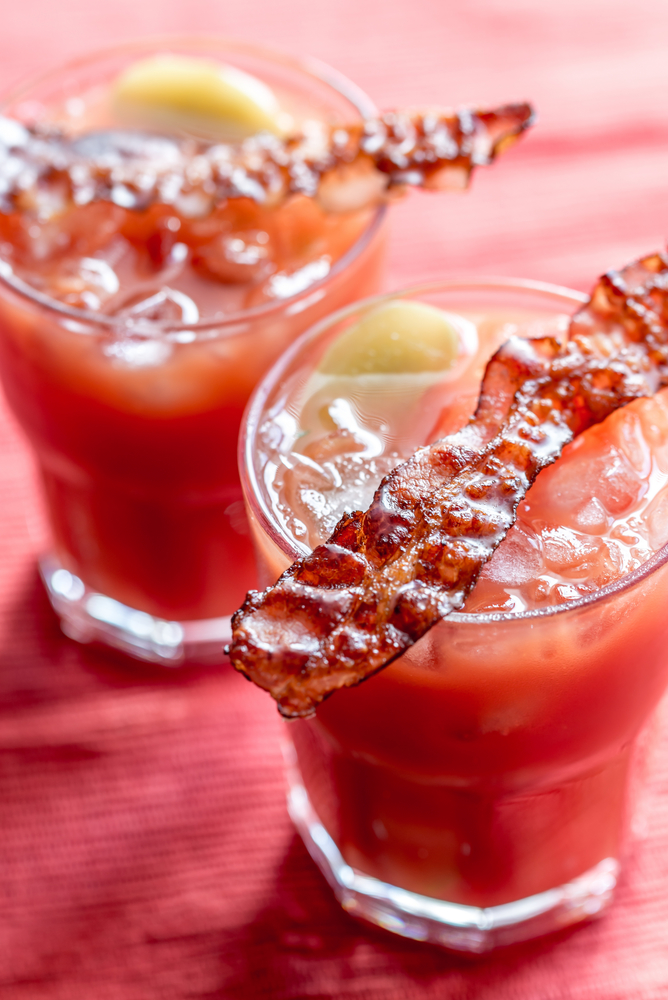 Two glasses of Bloody Mary with bacon rashers