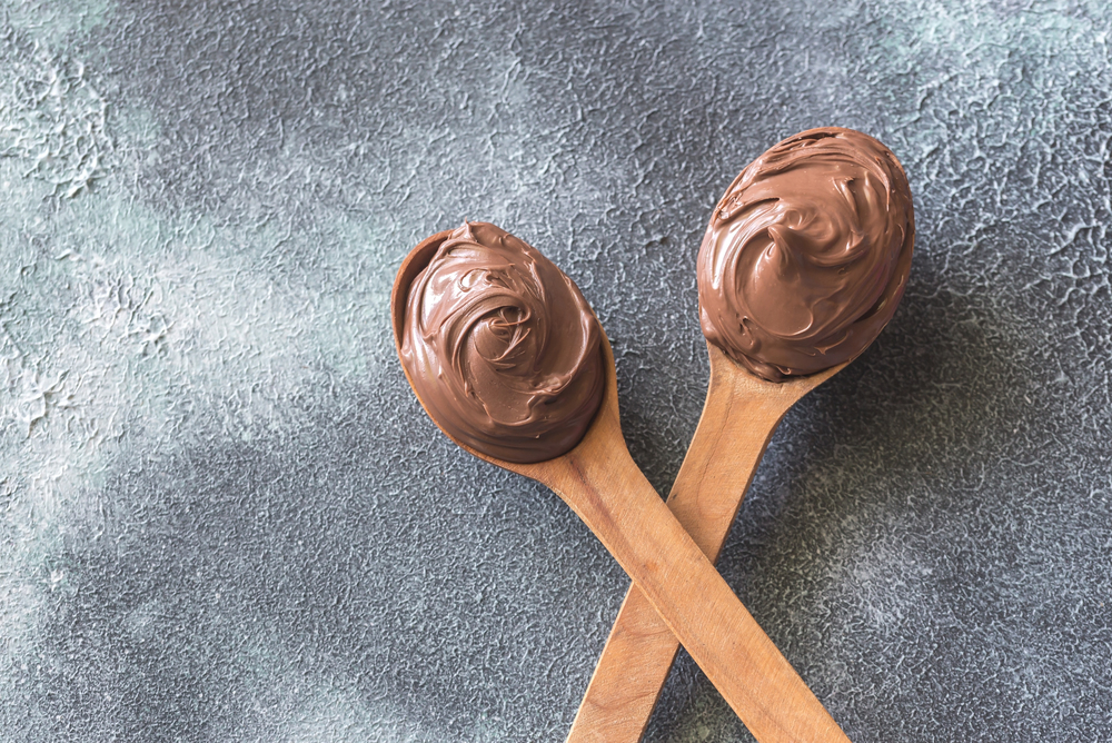 Two wooden spoons of chocolate cream