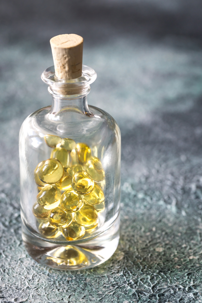 Omega-3 fish oil capsules in the glass bottle