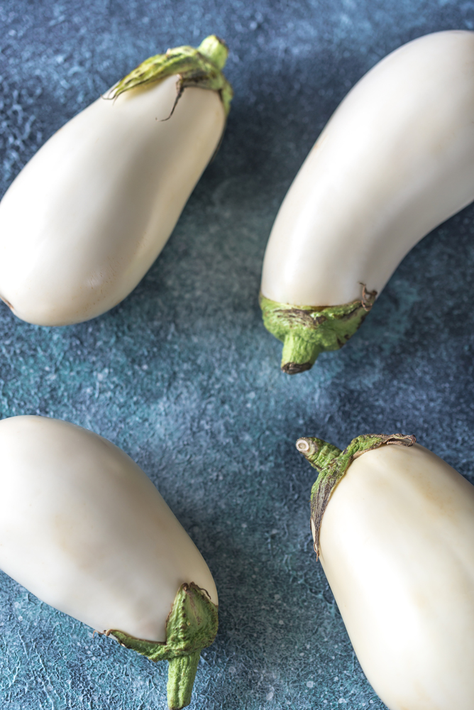 White aubergines on the wooden background