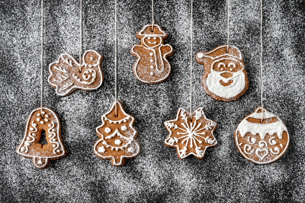 Christmas tree decoration gingerbread cookies on the powdered background