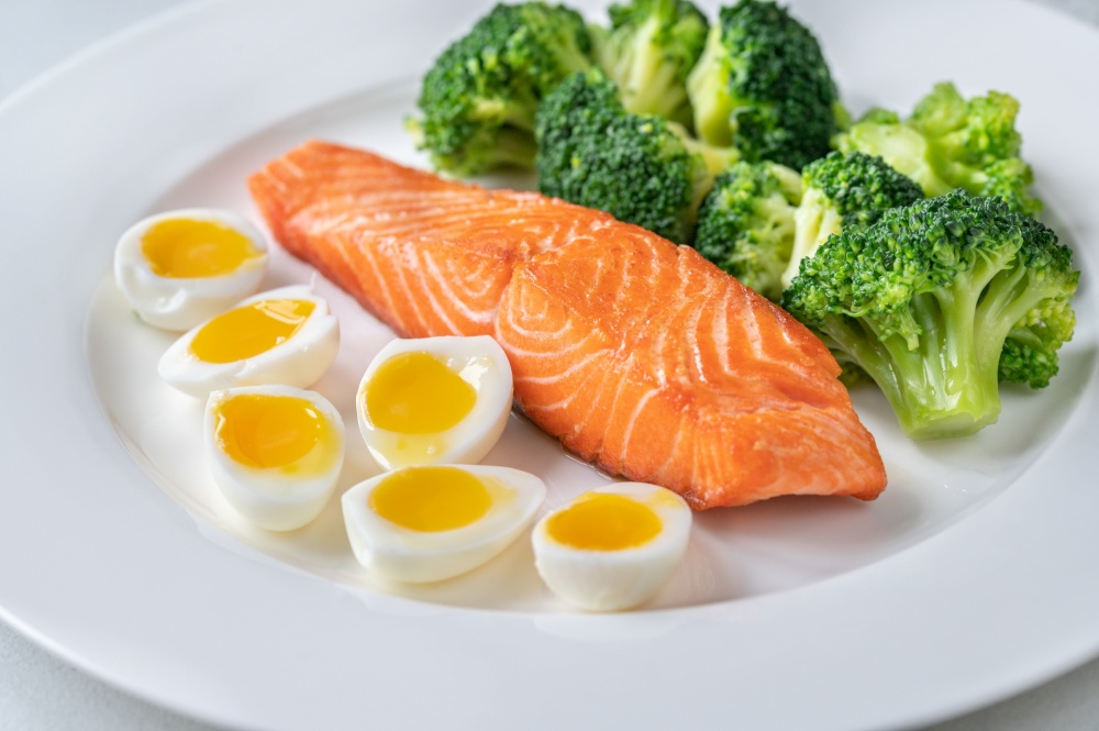 Portion of  salmon with broccoli and eggs