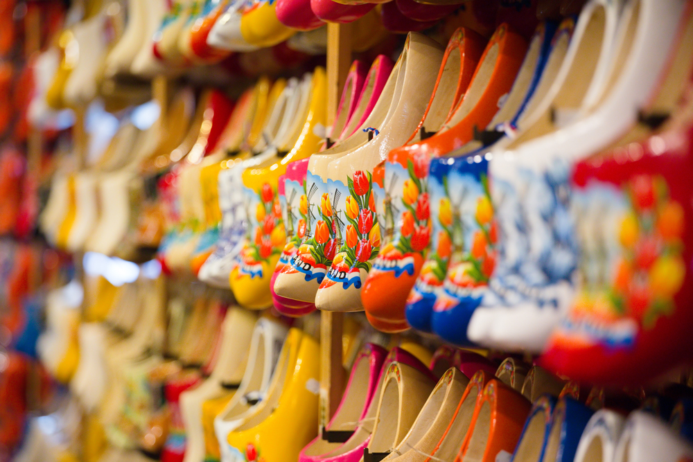 lot of multicolored souvenir Dutch wooden shoes klomp in the shop