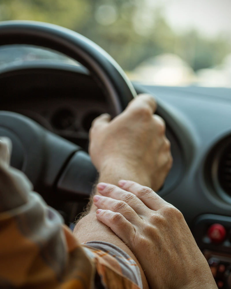 male hands on steering wheel