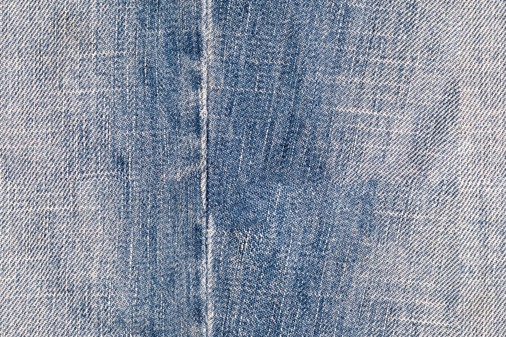 Indigo denim seamless texture. Jeans background. Fabric wallpaper. Close-up grunge old canvas surface. Macro backdrop. Indigo denim seamless texture. Jeans background