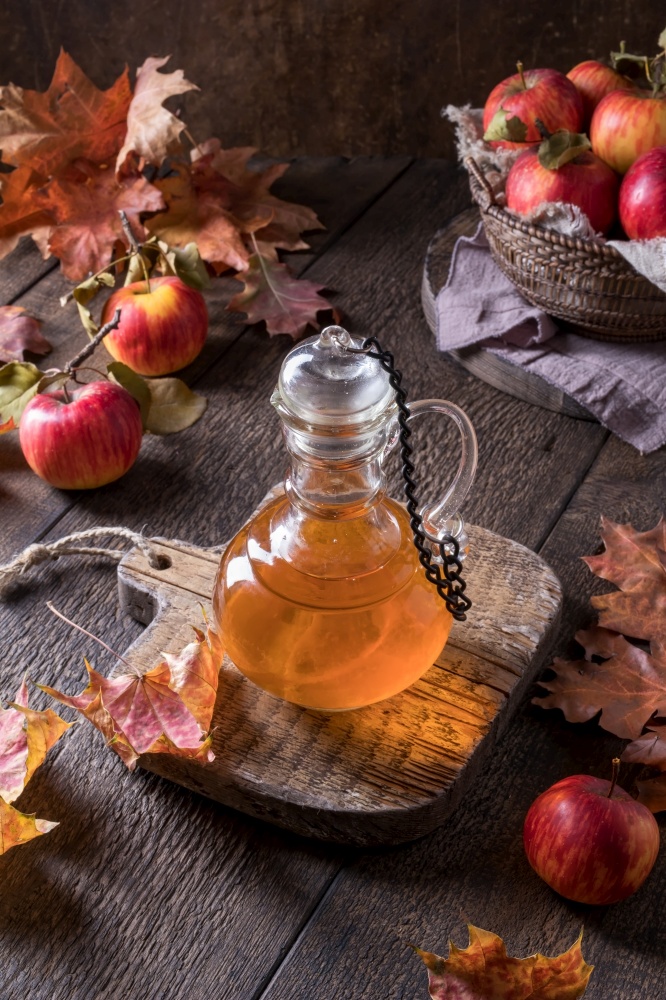 A transparent bottle of apple cider vinegar on a table