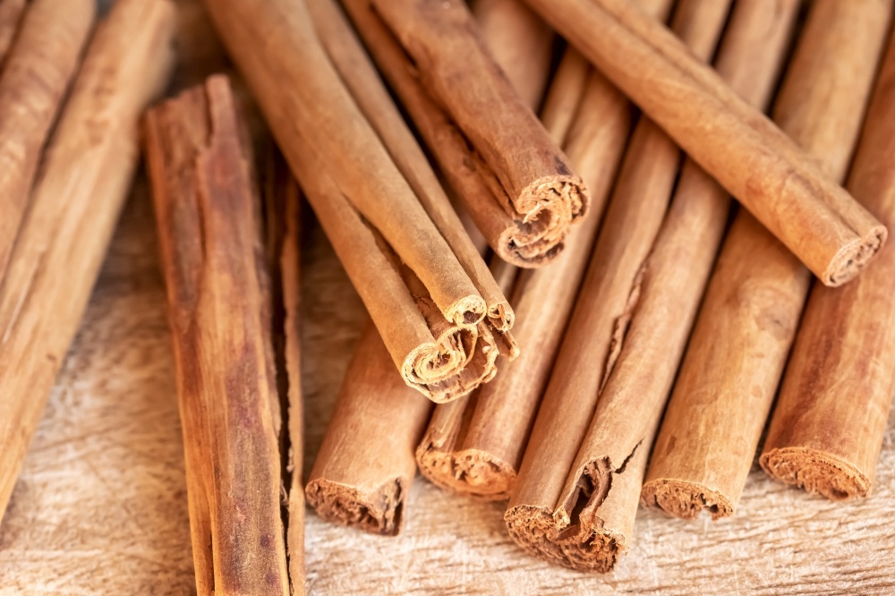 True or Ceylon cinnamon sticks on a table, close up