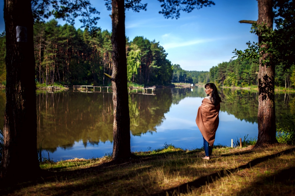 Girl posing against the backdrop of a lake or river. walk in nature.. Girl posing against the backdrop of a lake or river. walk in nature