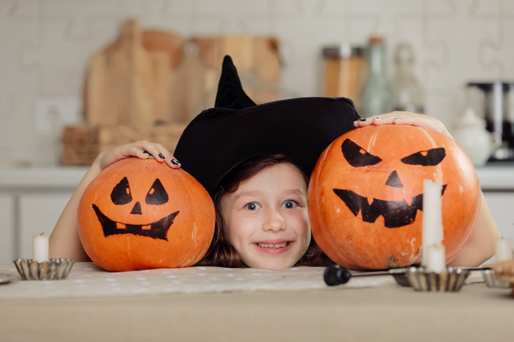 Happy halloween. Cute little girl in witch costume with carving pumpkin. Happy family preparing for Halloween. Happy halloween. Cute little girl in witch costume with carving pumpkin. Happy family preparing for Halloween.