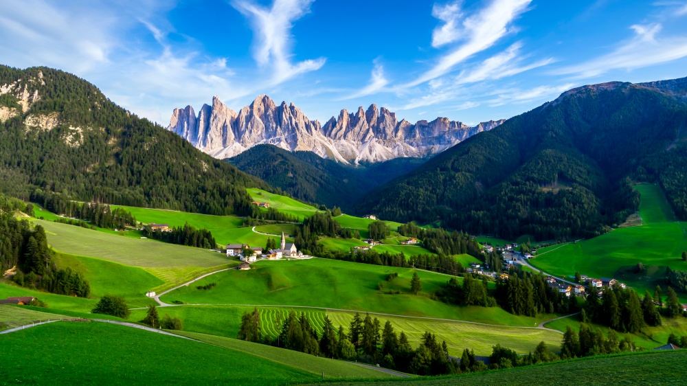 Village in the Dolomites mountain peaks in the Val di Funes, La Villa alpine village in Dolomites Mountains, St. Magdalena or Santa Maddalena with characteristic church, South Tyrol, Italy