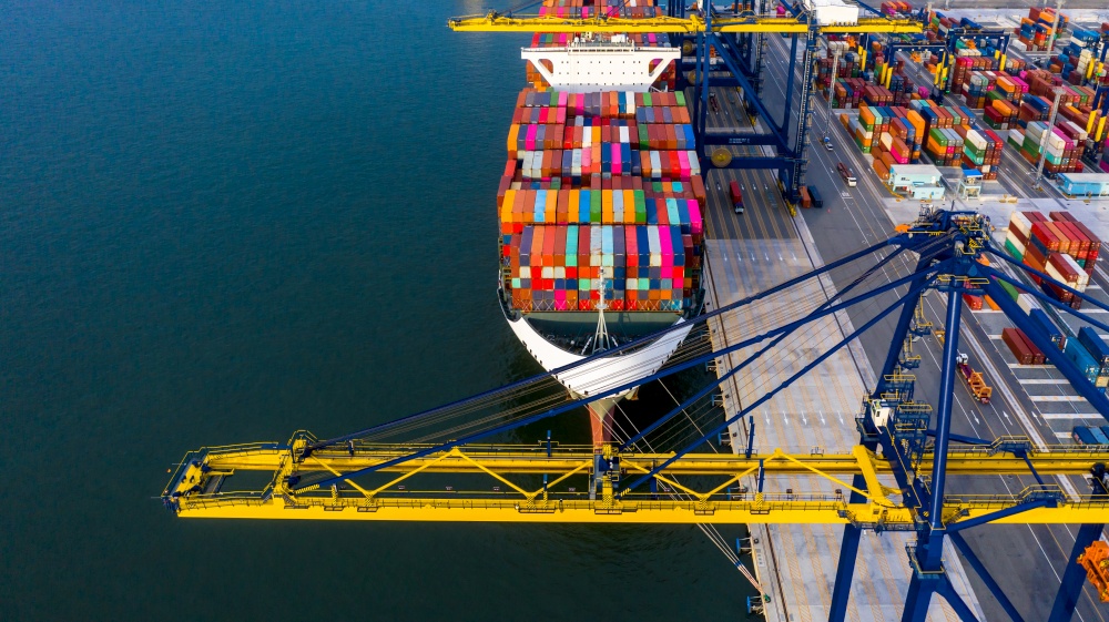 Container ship in deep sea port, Global business logistic import export freight shipping transportation oversea worldwide by container ship, Container vessel loading cargo cargo freight ship, Aerial view.