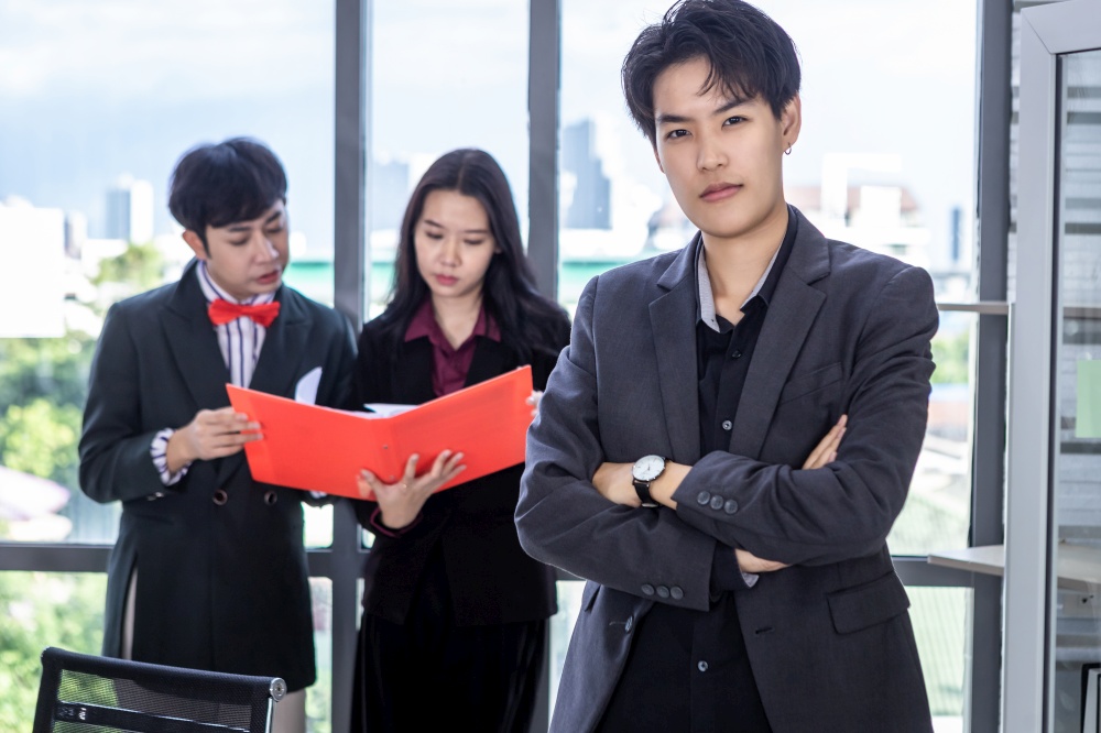Asian Young tomboy lesbian business with arms folded and of woman and coaching personal Employees Homosexual businessman LGBT while working together in office