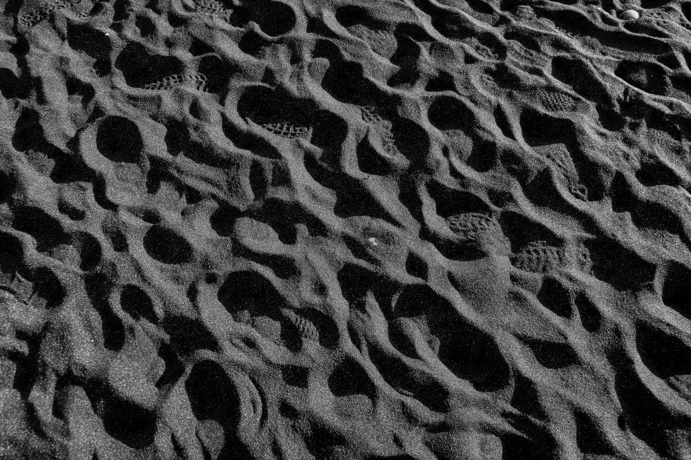 footprints in the black sand