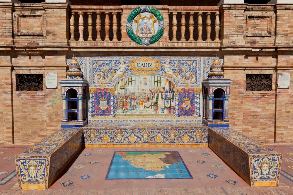 Tiled Alcoves of Spanish Provinces Along the Walls of Plaza de Espana in Seville, Spain. Cadiz Region Close Up Painted Ceramic Ornament Representing City with Bench and Map, Designed for Expo 1928