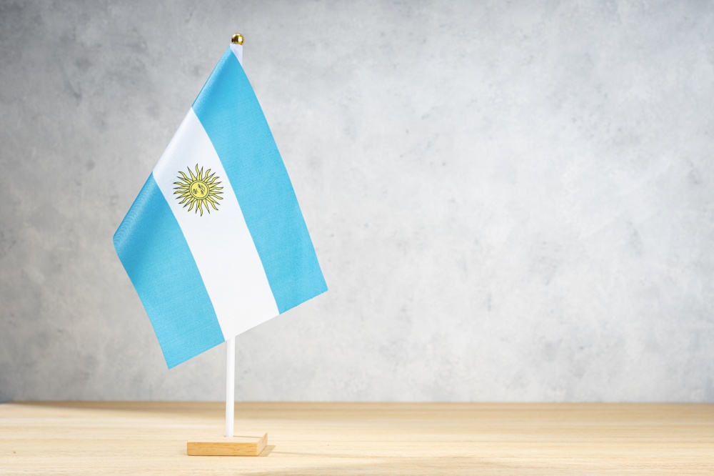 Argentina table flag on white textured wall. Copy space for text, designs or drawings