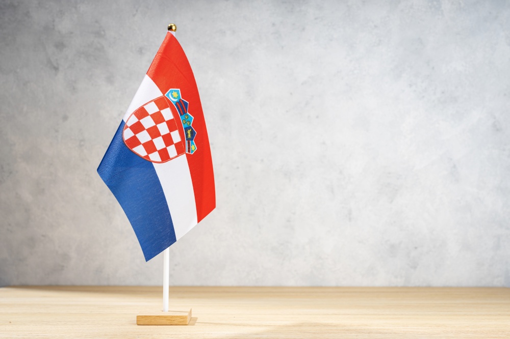 Croatia table flag on white textured wall. Copy space for text, designs or drawings