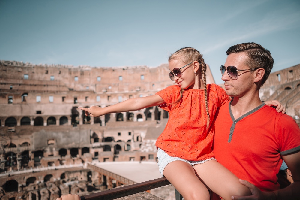 Young father and little girl in Coliseum, Rome, Italy. Family portrait at famous places in Europe. Happy family in Rome over Coliseum background