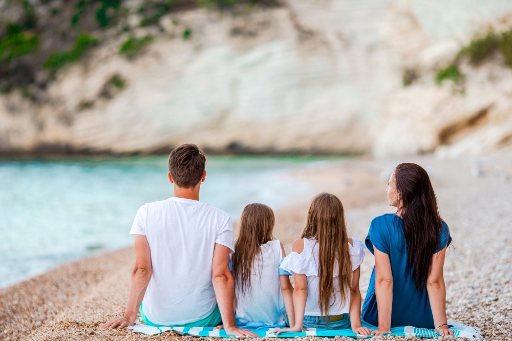 Happy family on the seashore together. Young family on vacation have a lot of fun