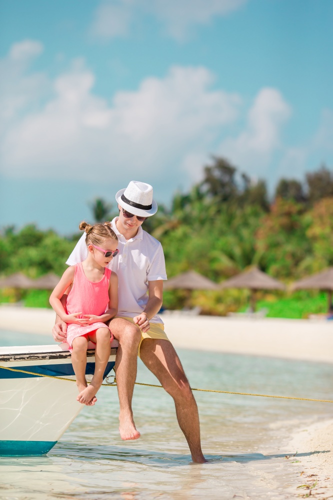 Father and little kid on the beach. Family enjoy beach vacation. Happy father and his adorable little daughter at tropical beach having fun