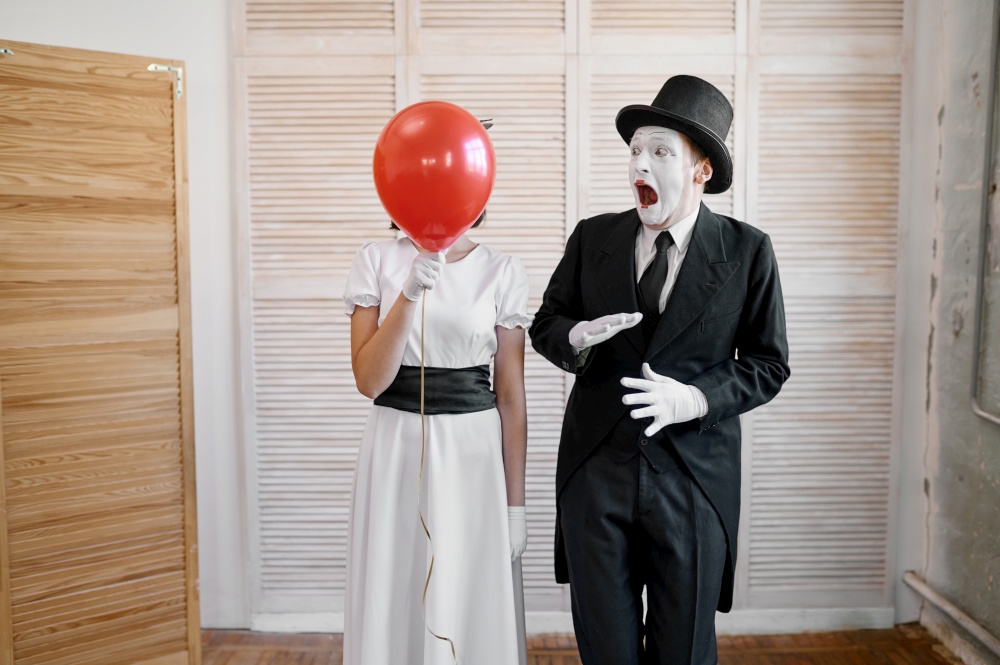 Two mime artists with air balloon, comedy parody. Pantomime theater, comedian, positive emotion, humour performance, funny face mimic and grimace. Two mime artists with air balloon, comedy parody