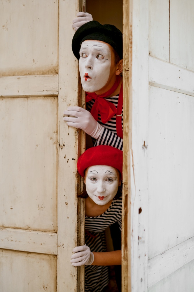 Male and female mime artists, parody comedy. Pantomime theater, comedian, positive emotion, humour performance, funny face mimic and grimace. Male and female mime artists, parody comedy