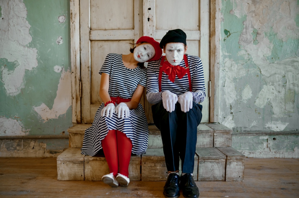 Two clowns, mime artists, parody comedy. Pantomime theater, comedian, positive emotion, humour performance, funny face mimic and grimace. Two clowns, mime artists, parody comedy